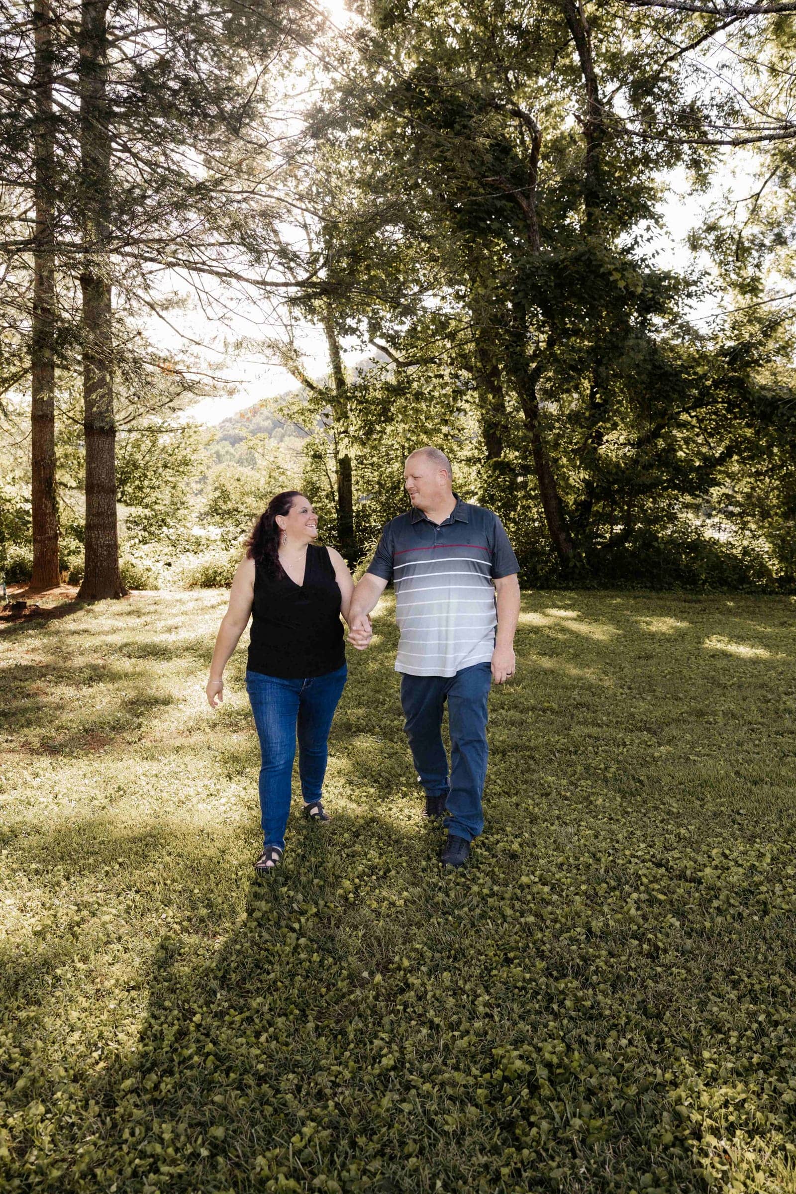 Chris and Jennifer Martin walking hand in hand and smiling