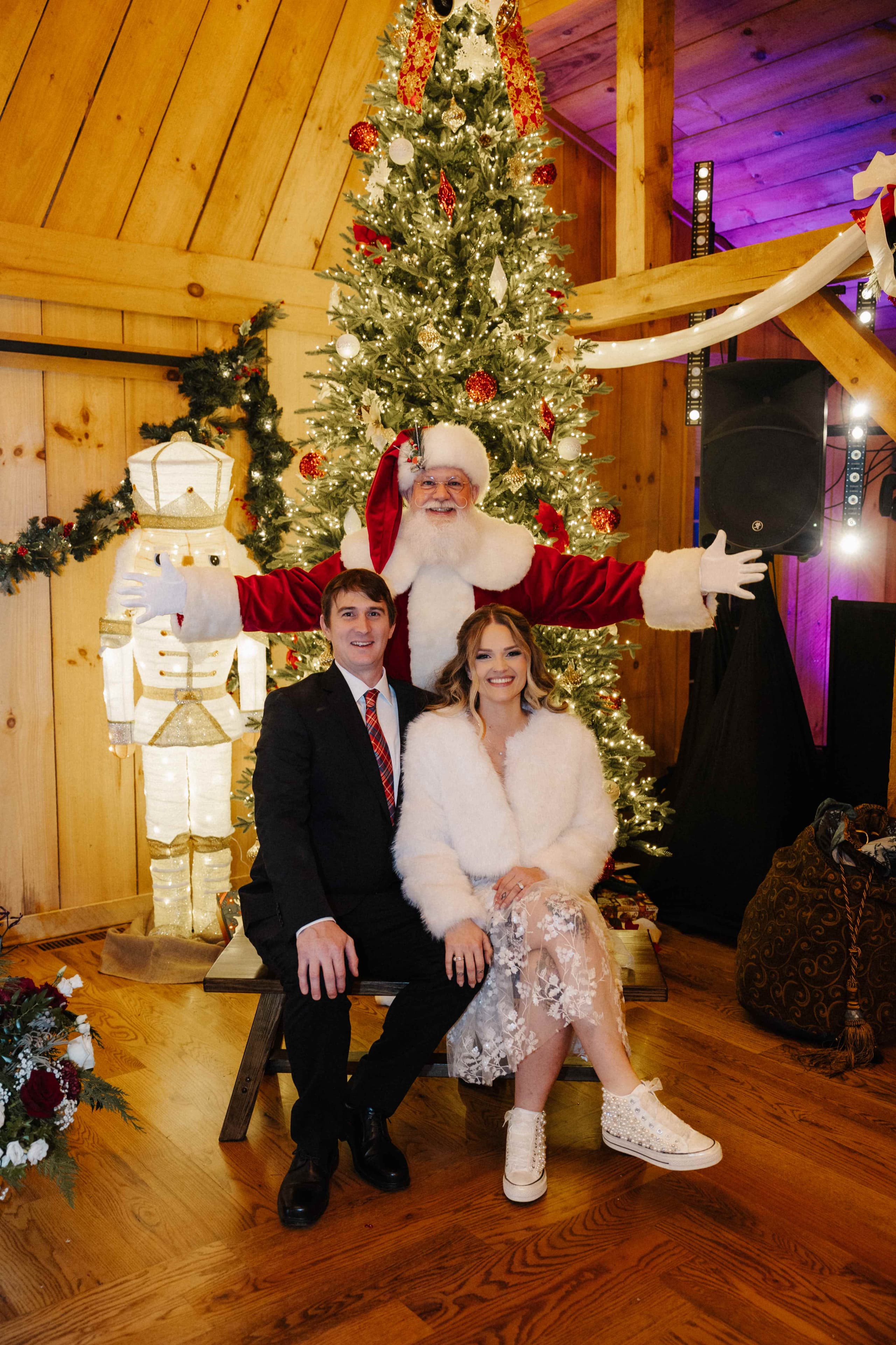 Couple with Santa Claus at Christmas tree with nutcracker decoration
