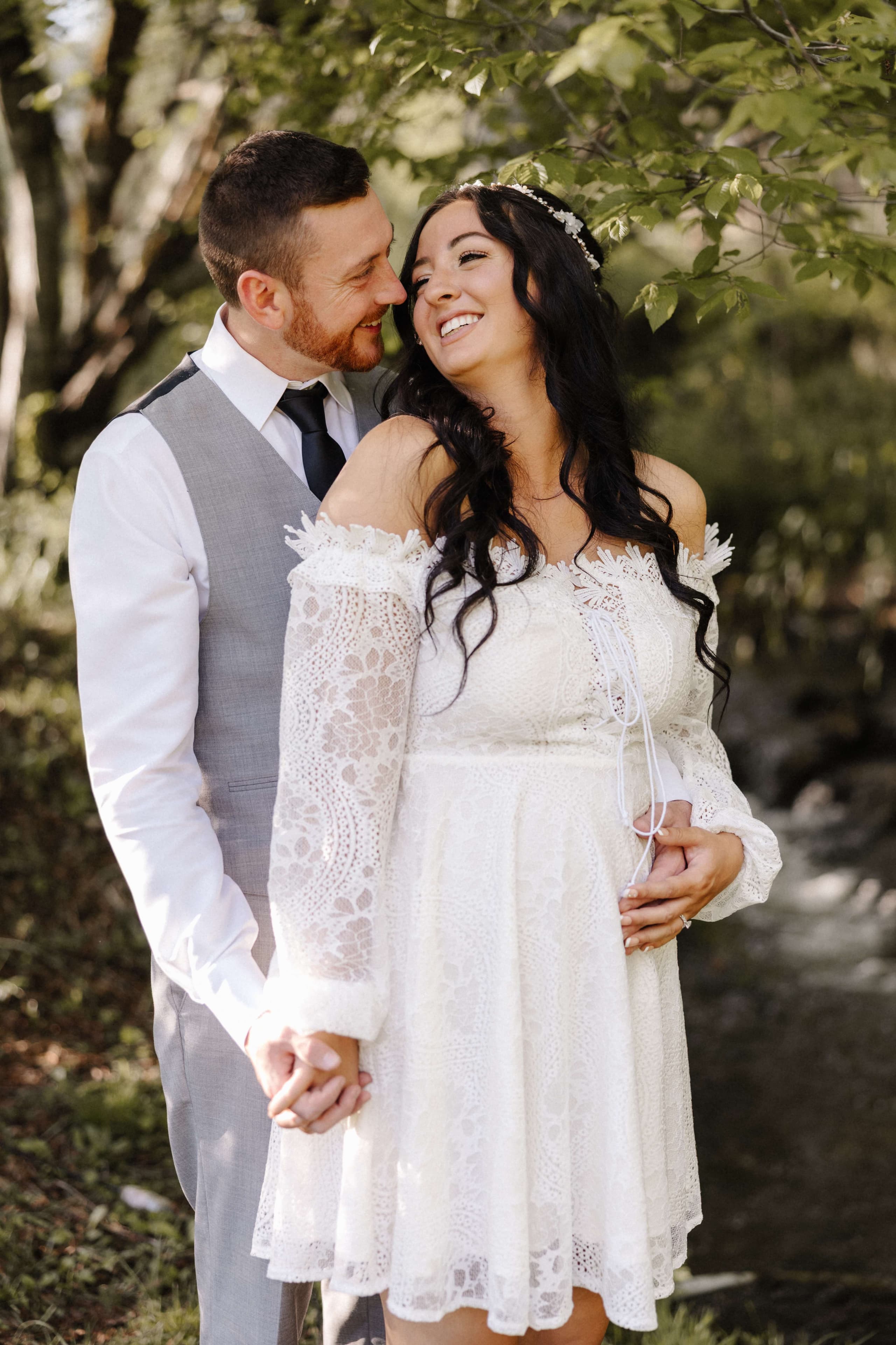 Intimate couple portrait laughing together in forest setting
