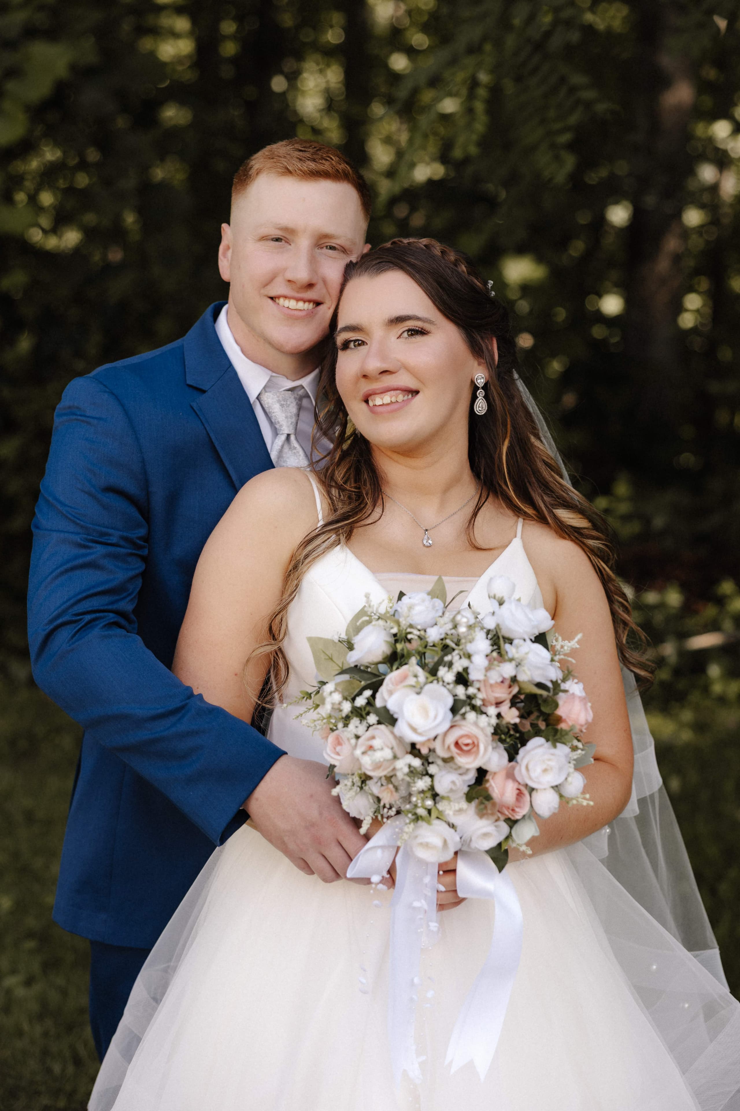 Close-up couple portrait with bride holding bouquet