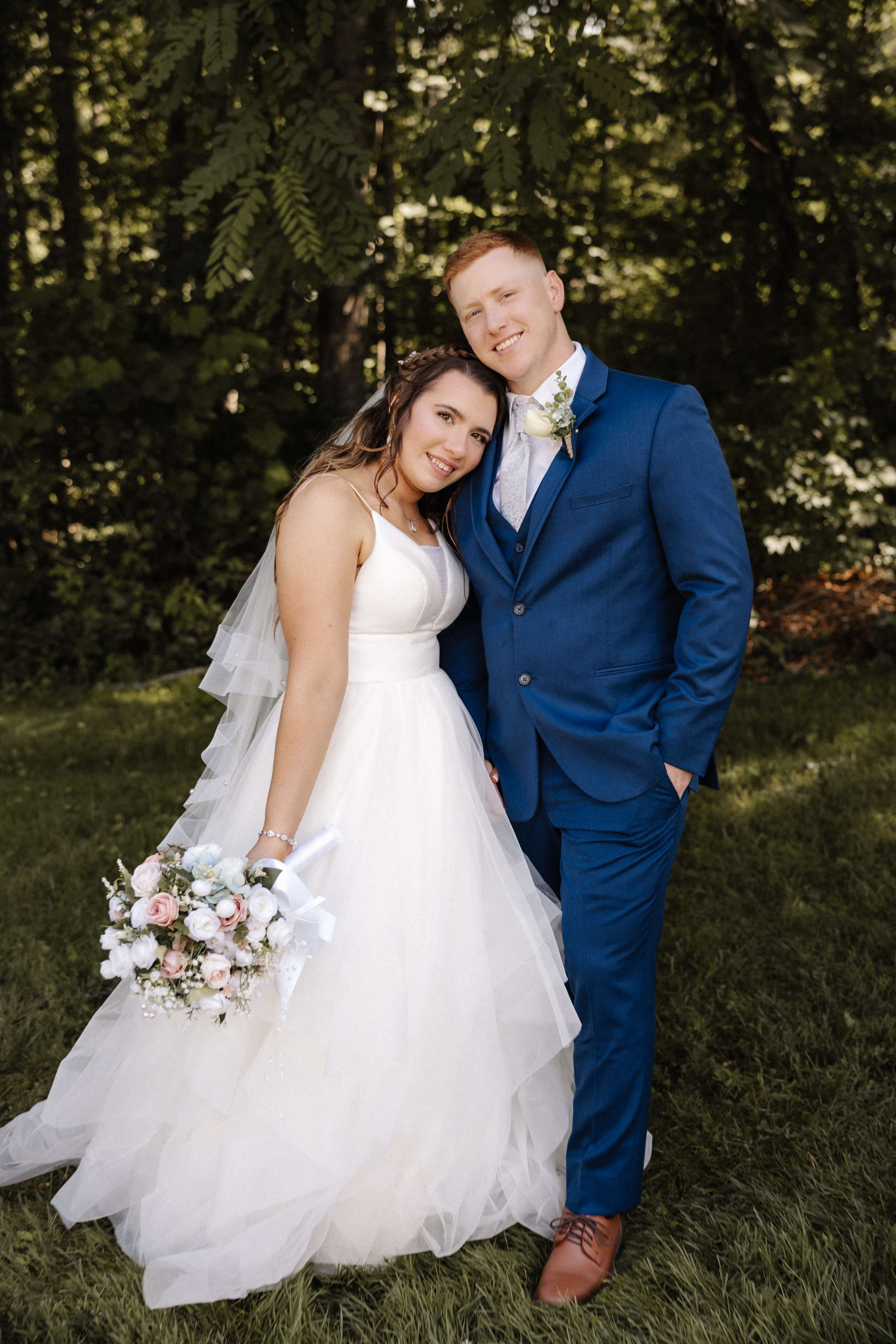 Full length couple portrait with groom in navy blue suit