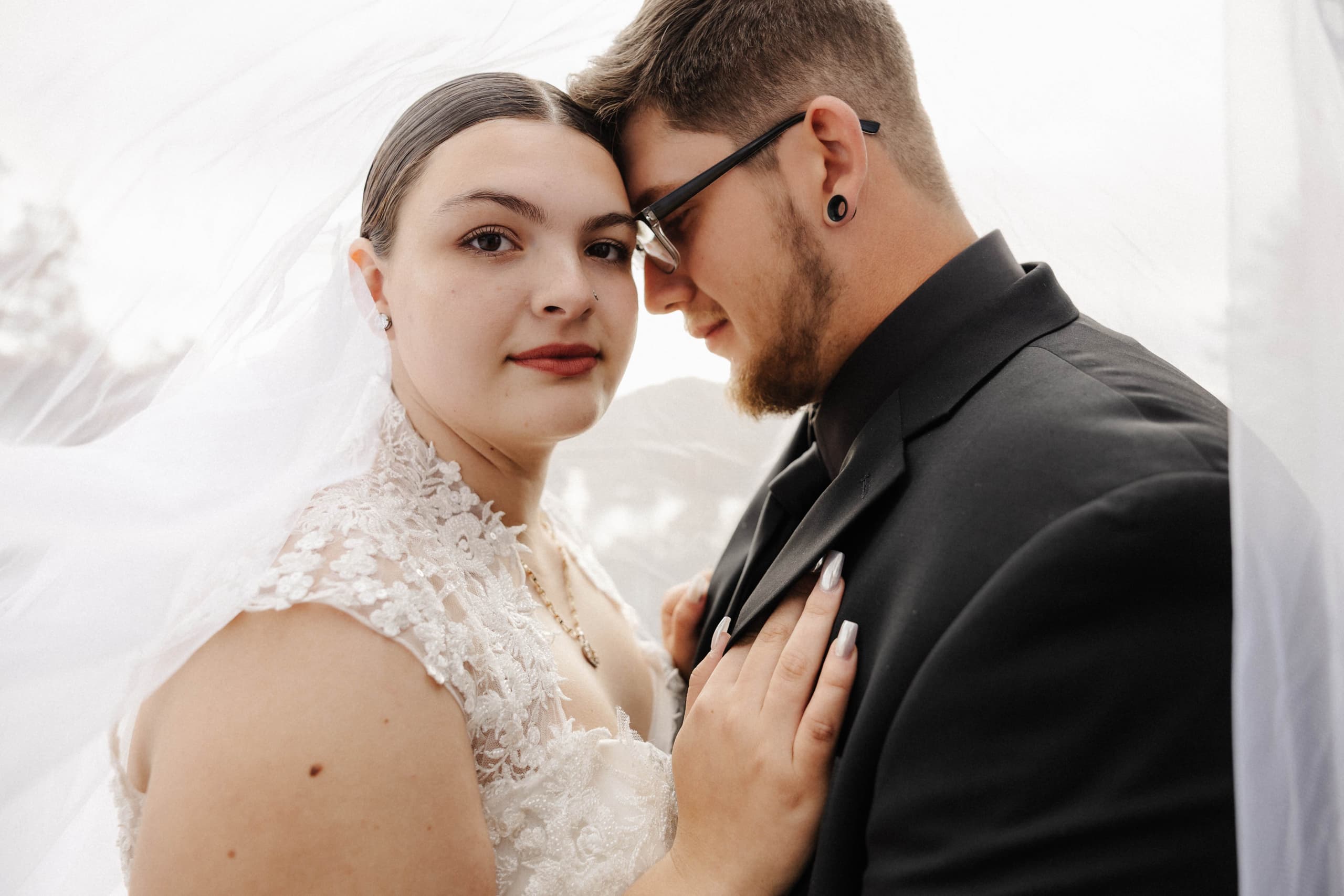 Intimate close-up portrait under veil with soft light