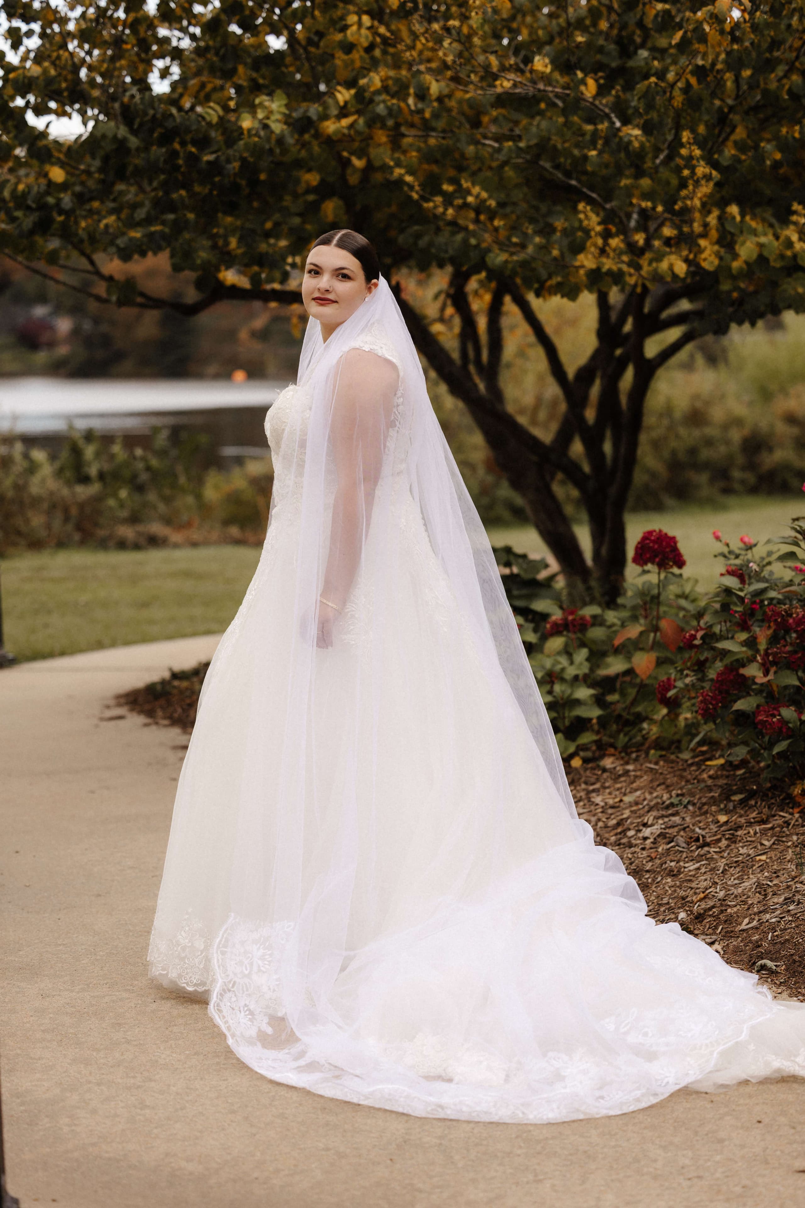Bride solo portrait from behind showing dress train and cathedral veil