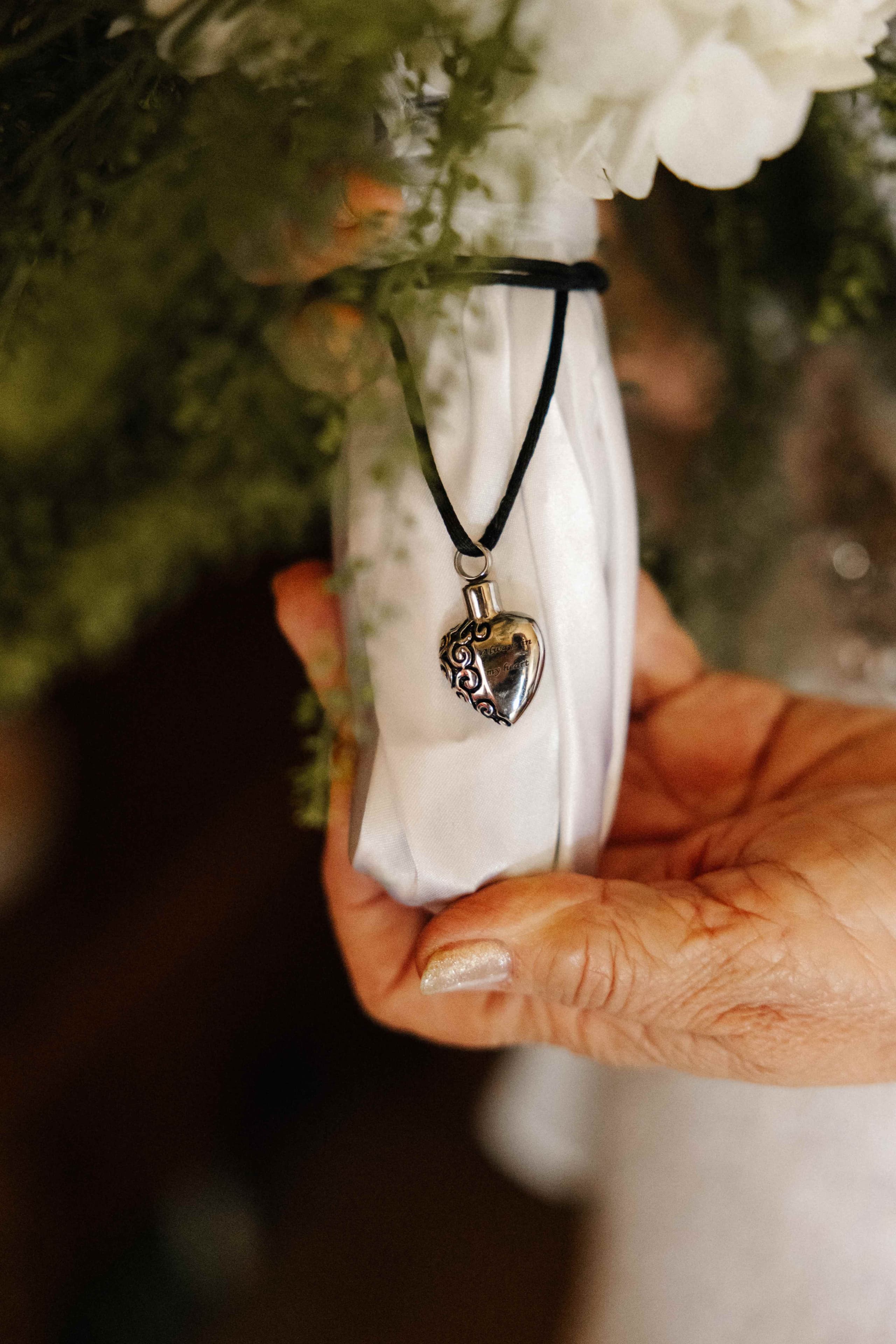 Silver heart locket memorial charm on bouquet wrap detail